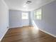 Cozy bedroom featuring a brick fireplace and wood-style flooring at 2666 Frontier Trl, Atlanta, GA 30341
