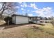 Home's backyard with a fenced-in yard and sunroom at 3376 Irish Ln, Decatur, GA 30032