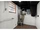 Basement utility area with hot water tank and painted brick walls at 3376 Irish Ln, Decatur, GA 30032