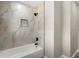 A renovated bathroom offers a sleek shower with modern fixtures and designer tile at 3376 Irish Ln, Decatur, GA 30032