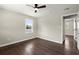 This bedroom features a ceiling fan, hardwood floors, and a sunny window view at 3376 Irish Ln, Decatur, GA 30032