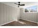 This bedroom has a ceiling fan, luxury vinyl floors, natural light, and paneled walls at 3376 Irish Ln, Decatur, GA 30032