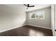 A clean and bright bedroom with hardwood floors, fan, and a large window offers great living at 3376 Irish Ln, Decatur, GA 30032