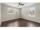 An inviting bedroom with windows, ceiling fan, and gleaming hardwood floors is move-in ready at 3376 Irish Ln, Decatur, GA 30032