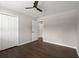 This bedroom features hardwood floors, a ceiling fan, and access to another room at 3376 Irish Ln, Decatur, GA 30032