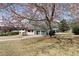 Beautiful home exterior with a spacious front yard, mature trees, and a two-car garage at 3376 Irish Ln, Decatur, GA 30032