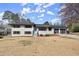 Charming two-story home with brick exterior, wood shutters, a well-maintained lawn, and two-car garage at 3376 Irish Ln, Decatur, GA 30032