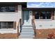 Inviting home entrance with light blue door, wood shutters, concrete steps and painted white brick at 3376 Irish Ln, Decatur, GA 30032