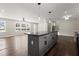Open-concept kitchen with a center island, hardwood floors, and plenty of natural light at 3376 Irish Ln, Decatur, GA 30032
