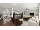 Open-concept living room and kitchen with stainless steel appliances, island seating, and a modern design at 3376 Irish Ln, Decatur, GA 30032