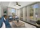 Cozy sunroom featuring large windows with curtains, comfortable seating, and a ceiling fan at 3376 Irish Ln, Decatur, GA 30032