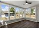 Bright sunroom with lots of windows offering views of the outdoors and wood floors at 3376 Irish Ln, Decatur, GA 30032