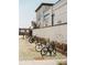 Community bike rack area with multiple bicycles and decorative landscaping at 653 Summit Hill Way, Cumming, GA 30040