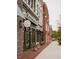 Street view of storefronts with decorative awnings, inviting displays, and planters with colorful flowers at 653 Summit Hill Way, Cumming, GA 30040