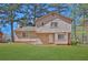 Exterior view of home with a well-kept lawn and tree-lined background at 1045 Forest Path, Stone Mountain, GA 30088