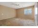 Spacious bedroom featuring a ceiling fan, a window, and carpeted floors at 1045 Forest Path, Stone Mountain, GA 30088