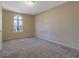 Spacious bedroom featuring neutral walls and carpet, lit by a sunny window at 1045 Forest Path, Stone Mountain, GA 30088