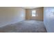 Neutral carpeted bedroom with a window providing natural light at 1045 Forest Path, Stone Mountain, GA 30088