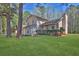 Beautiful two-story home featuring a well-maintained front yard and mature trees offering ample shade at 1045 Forest Path, Stone Mountain, GA 30088