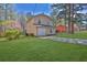 A detached garage with ample yard space surrounded by beautiful landscaping at 1045 Forest Path, Stone Mountain, GA 30088