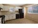 Bright kitchen with white cabinets, neutral walls, appliances and a window at 1045 Forest Path, Stone Mountain, GA 30088