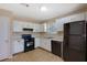 Galley-style kitchen features ample cabinet space, modern appliances, and a window at 1045 Forest Path, Stone Mountain, GA 30088