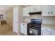 Kitchen with ample cabinet space and view through to the living area at 1045 Forest Path, Stone Mountain, GA 30088