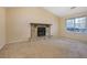 Cozy living room featuring a stone fireplace, neutral carpeting, and bright natural light at 1045 Forest Path, Stone Mountain, GA 30088
