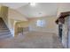 Spacious living room with a stone fireplace and ample natural light, adjacent to an open staircase at 1045 Forest Path, Stone Mountain, GA 30088