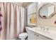 Cozy bathroom featuring a shower-tub combo with white vanity, and a large framed mirror at 1109 Pine Grove Ne Ave, Brookhaven, GA 30319