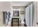 Bathroom featuring a shower-tub combo with a glass vanity and sink with a framed mirror at 1109 Pine Grove Ne Ave, Brookhaven, GA 30319