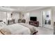 Bedroom featuring a seating area, TV, ensuite bathroom, and neutral walls and carpet at 1109 Pine Grove Ne Ave, Brookhaven, GA 30319