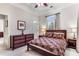 Bedroom with tray ceilings features a bed with patterned bedding, and matching wooden dresser at 1109 Pine Grove Ne Ave, Brookhaven, GA 30319