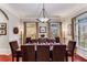 Formal dining room with wood floors, crown molding, and a large table with seating for ten at 1109 Pine Grove Ne Ave, Brookhaven, GA 30319