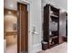 Residential elevator with wood-paneled interior and folding door, located next to custom shelving at 1109 Pine Grove Ne Ave, Brookhaven, GA 30319