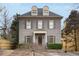 A traditional gray brick home boasts dormer windows, a covered porch, and neatly manicured landscaping at 1109 Pine Grove Ne Ave, Brookhaven, GA 30319