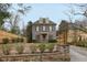 A traditional gray brick home boasts dormer windows, a covered porch, and neatly manicured landscaping at 1109 Pine Grove Ne Ave, Brookhaven, GA 30319