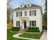 Charming white two-story home with dormer windows, black shutters, and landscaped front yard at 1109 Pine Grove Ne Ave, Brookhaven, GA 30319