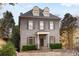 A traditional gray brick home boasts dormer windows, a covered porch, and neatly manicured landscaping at 1109 Pine Grove Ne Ave, Brookhaven, GA 30319