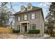Charming gray brick home with a manicured lawn and classic architectural details at 1109 Pine Grove Ne Ave, Brookhaven, GA 30319