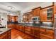 Open kitchen with cherry cabinets, granite countertops, stainless steel appliances, and a gas cooktop at 1109 Pine Grove Ne Ave, Brookhaven, GA 30319