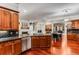 Large kitchen with an island, granite countertops, cherry cabinets, stainless steel appliances, and open dining space at 1109 Pine Grove Ne Ave, Brookhaven, GA 30319