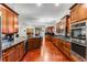 Spacious kitchen with cherry cabinets, granite countertops, stainless steel appliances, and wood floors at 1109 Pine Grove Ne Ave, Brookhaven, GA 30319
