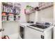 Laundry room equipped with shelves for storage and modern Samsung washer and dryer appliances at 1109 Pine Grove Ne Ave, Brookhaven, GA 30319