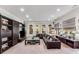 Spacious living room features recessed lighting, a leather sofa, and elegant arched windows at 1109 Pine Grove Ne Ave, Brookhaven, GA 30319