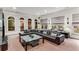 Cozy living room features recessed lights, a leather sofa, and multiple windows with blinds at 1109 Pine Grove Ne Ave, Brookhaven, GA 30319