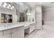 The bright main bathroom features a double sink vanity, large mirror, and separate tub and shower at 1109 Pine Grove Ne Ave, Brookhaven, GA 30319
