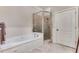 Relaxing soaking tub and separate shower are featured in this main bathroom at 1109 Pine Grove Ne Ave, Brookhaven, GA 30319