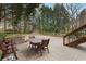 Outdoor patio features a stone bench, wood table and chairs, and stairs to an upper level at 1109 Pine Grove Ne Ave, Brookhaven, GA 30319