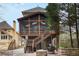 Back of house showing the elevated screened in porch and lower level patio at 1109 Pine Grove Ne Ave, Brookhaven, GA 30319